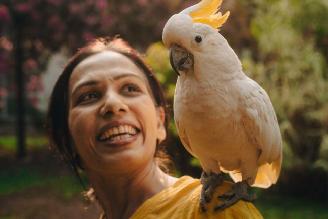 Woman with a bird on her shoulder